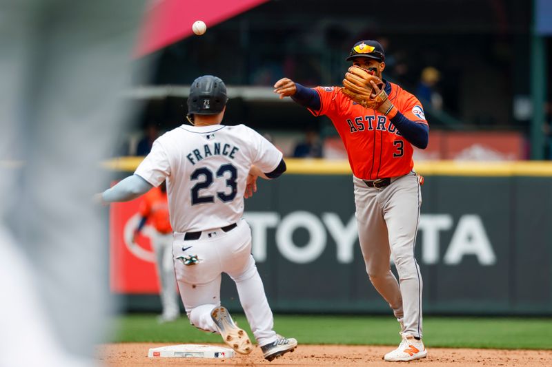 May 30, 2024; Seattle, Washington, USA; Houston Astros shortstop Jeremy Pena (3) turns a double play against Seattle Mariners first baseman Ty France (23) during the fourth inning at T-Mobile Park. Mandatory Credit: Joe Nicholson-USA TODAY Sports