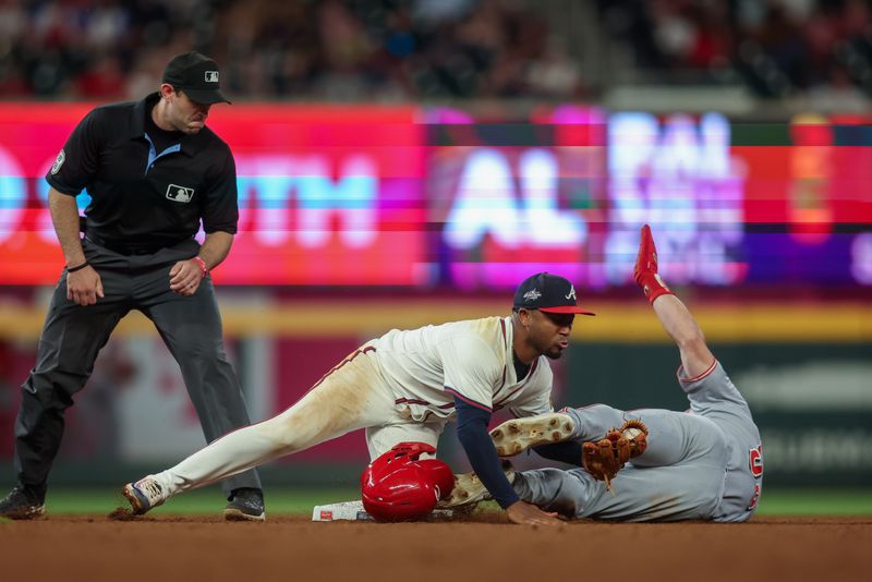 May 8, 2025; Atlanta, Georgia, USA; Atlanta Braves second baseman Ozzie Albies (1) tags out Cincinnati Reds outfielder Blake Dunn (59) on a steal attempt in the eleventh inning at Truist Park. Mandatory Credit: Brett Davis-Imagn Images
