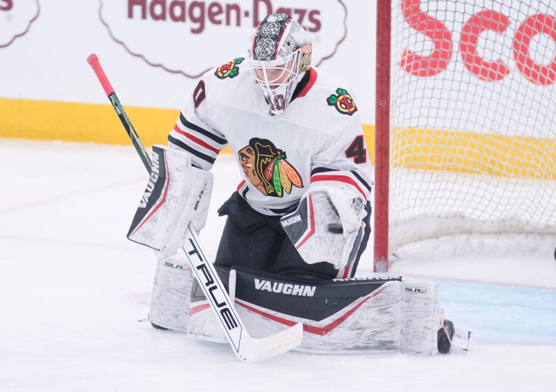 Dec 2, 2024; Toronto, Ontario, CAN; Chicago Blackhawks goaltender Arvid Soderblom (40) makes a glove save  during warm up before a game against the Toronto Maple Leafs at Scotiabank Arena. Mandatory Credit: John E. Sokolowski-Imagn Images