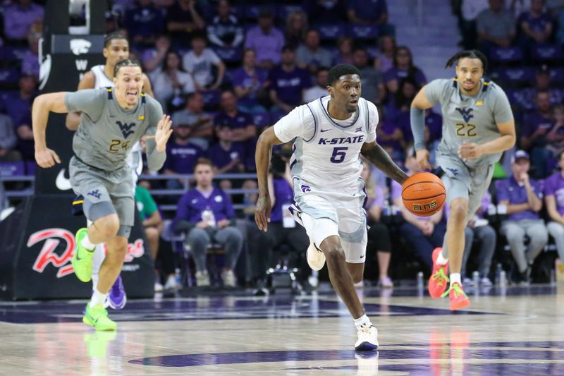 Feb 26, 2024; Manhattan, Kansas, USA; Kansas State Wildcats guard Cam Carter (5) dribbles the ball during the first half against the West Virginia Mountaineers at Bramlage Coliseum. Mandatory Credit: Scott Sewell-USA TODAY Sports