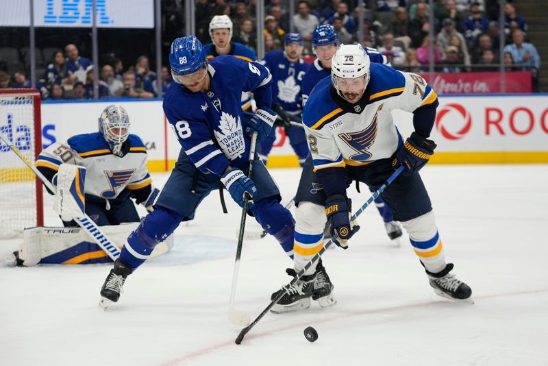 Oct 24, 2024; Toronto, Ontario, CAN; St. Louis Blues defenseman Justin Faulk (72) knocks the puck away from Toronto Maple Leafs forward William Nylander (88) during the third period at Scotiabank Arena. Mandatory Credit: John E. Sokolowski-Imagn Images