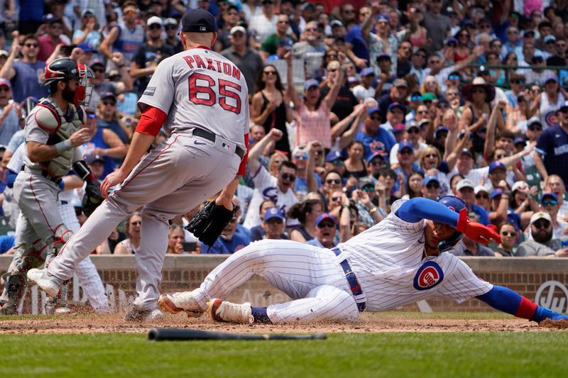 Jul 15, 2023; Chicago, Illinois, USA; Chicago Cubs catcher Miguel Amaya (6) is safe at home plate as Boston Red Sox starting pitcher James Paxton (65) cover the plate during the third inning at Wrigley Field. Mandatory Credit: David Banks-USA TODAY Sports