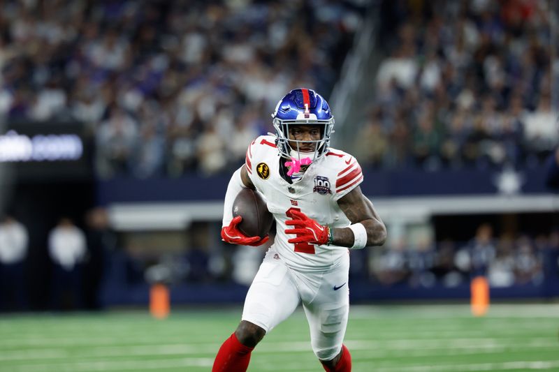 New York Giants wide receiver Malik Nabers (1) carries the ball after a reception during an NFL football game against the Dallas Cowboys on Thursday, Nov. 28, 2024, in Arlington, Texas. (AP Photo/Matt Patterson)