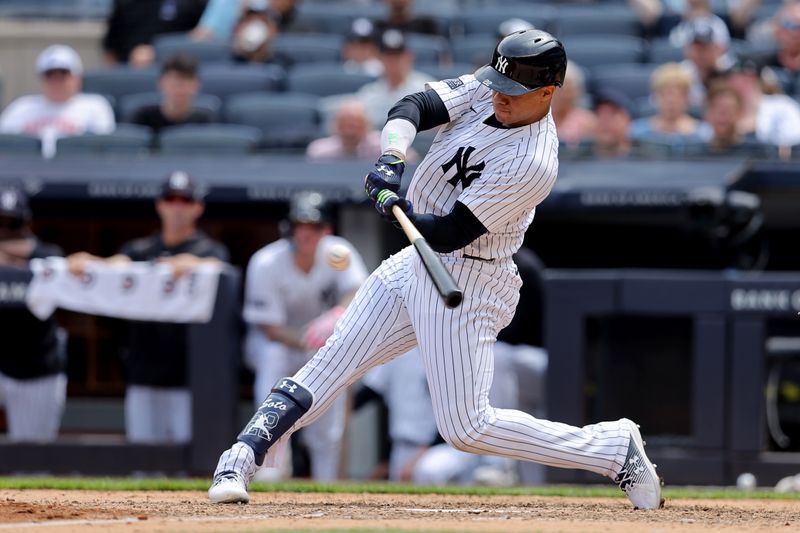 May 23, 2024; Bronx, New York, USA; New York Yankees right fielder Juan Soto (22) hits an RBI single against the Seattle Mariners during the seventh inning at Yankee Stadium. Mandatory Credit: Brad Penner-USA TODAY Sports