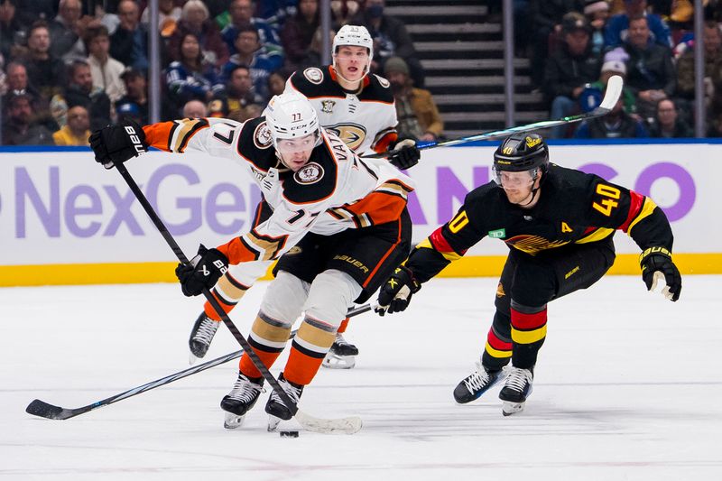 Nov 28, 2023; Vancouver, British Columbia, CAN; Vancouver Canucks forward Elias Pettersson (40) stick checks Anaheim Ducks forward Frank Vatrano (77) in the second period at Rogers Arena. Mandatory Credit: Bob Frid-USA TODAY Sports