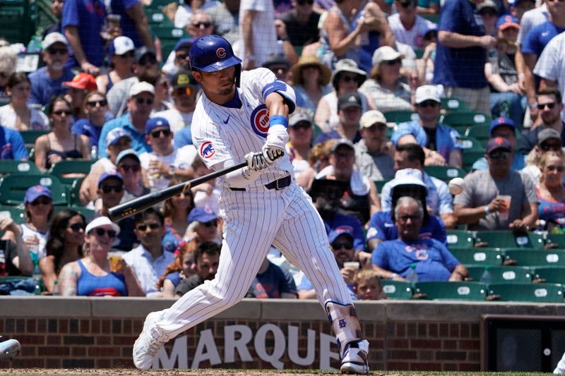 Jun 16, 2024; Chicago, Illinois, USA; Chicago Cubs outfielder Seiya Suzuki (27) singles against the St. Louis Cardinals during the fourth inning at Wrigley Field. Mandatory Credit: David Banks-USA TODAY Sports