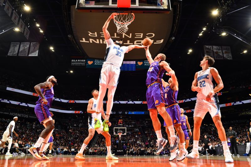 PHOENIX, AZ - NOVEMBER 18: Goga Bitadze #35 of the Orlando Magic goes up for the rebound during the game against the Phoenix Suns on November 18, 2024 at Footprint Center in Phoenix, Arizona. NOTE TO USER: User expressly acknowledges and agrees that, by downloading and or using this photograph, user is consenting to the terms and conditions of the Getty Images License Agreement. Mandatory Copyright Notice: Copyright 2024 NBAE (Photo by Barry Gossage/NBAE via Getty Images)