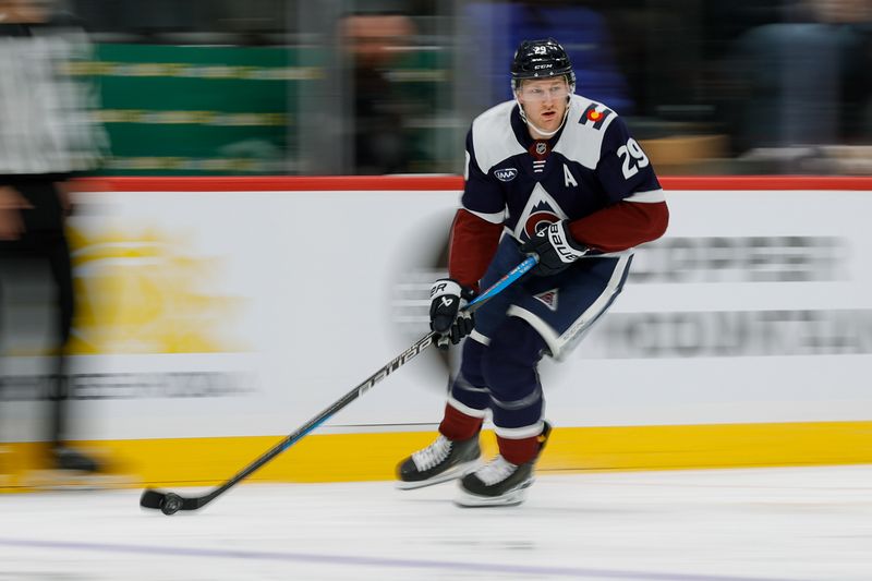 Dec 23, 2025; Denver, Colorado, USA; Colorado Avalanche center Nathan MacKinnon (29) controls the puck in the second period against the Utah Mammoth at Ball Arena. Mandatory Credit: Isaiah J. Downing-Imagn Images