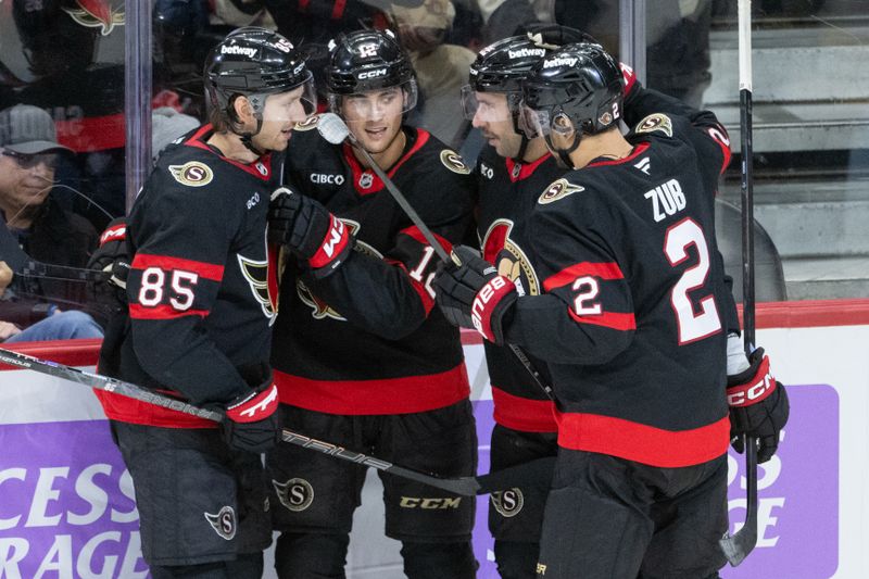 Nov 13, 2025; Ottawa, Ontario, CAN; Ottawa Senators center Shane Pinto (12) celebrates a goal wtih defenseman Jake Sanderson (85), right wing Michael Amadio (22) and defenseman Artem Zub (2) in the third period against the Boston Bruins at the Canadian Tire Centre. Mandatory Credit: Marc DesRosiers-IMAGN Images