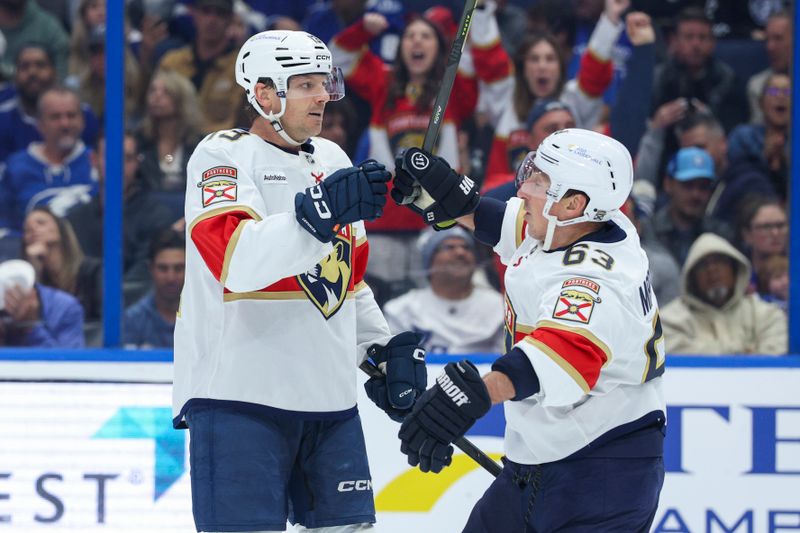 Dec 15, 2025; Tampa, Florida, USA; Florida Panthers left wing Brad Marchand (63) reacts to a goal scored by center Sam Reinhart (13) against the Tampa Bay Lightning in the second period at Benchmark International Arena. Mandatory Credit: Nathan Ray Seebeck-Imagn Images