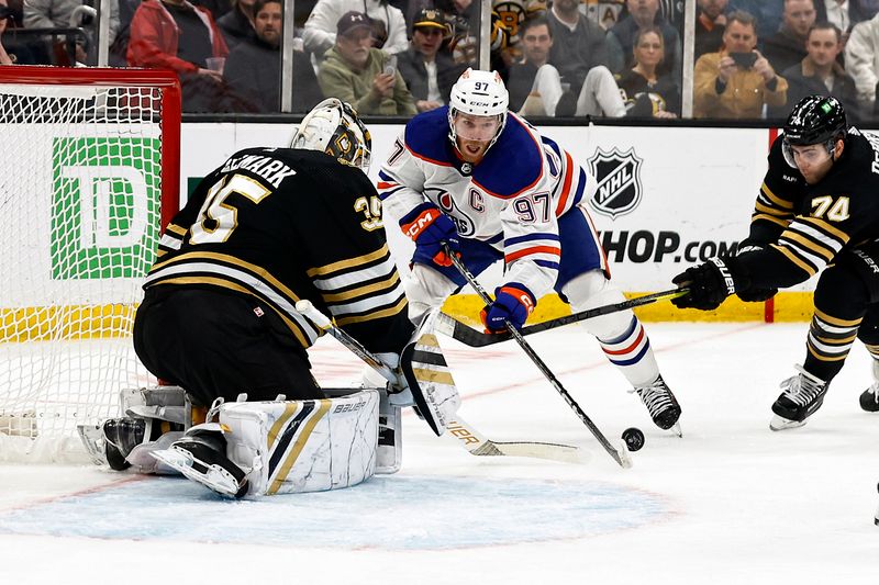 Mar 5, 2024; Boston, Massachusetts, USA; Boston Bruins left wing Jake DeBrusk (74) tries to stop Edmonton Oilers center Connor McDavid (97) from getting to the net during the first period at TD Garden. Mandatory Credit: Winslow Townson-USA TODAY Sports