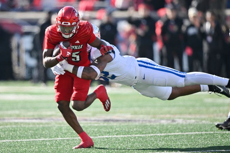 Nov 25, 2023; Louisville, Kentucky, USA;  Louisville Cardinals running back Jawhar Jordan (25) runs the ball against Kentucky Wildcats linebacker Trevin Wallace (32) during the first quarter at L&N Federal Credit Union Stadium. Mandatory Credit: Jamie Rhodes-USA TODAY Sports