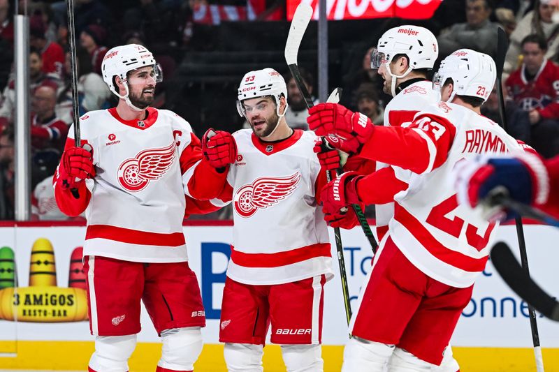 Jan 10, 2026; Montreal, Quebec, CAN; Detroit Red Wings center Dylan Larkin (71) celebrates with his teammates his goal against the Montreal Canadiens during the second period at Bell Centre. Mandatory Credit: David Kirouac-Imagn Images