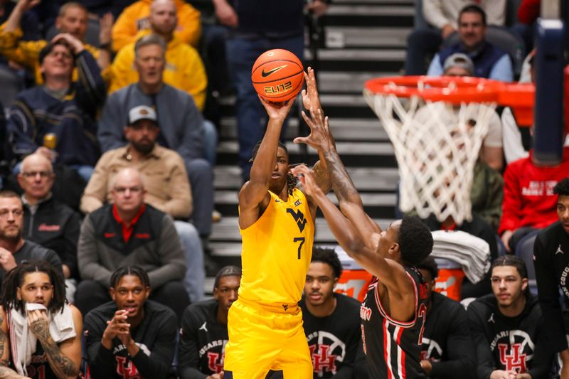 Jan 29, 2025; Morgantown, West Virginia, USA; West Virginia Mountaineers guard Javon Small (7) shoots a three point basket during the first half against the Houston Cougars at WVU Coliseum. Mandatory Credit: Ben Queen-Imagn Images