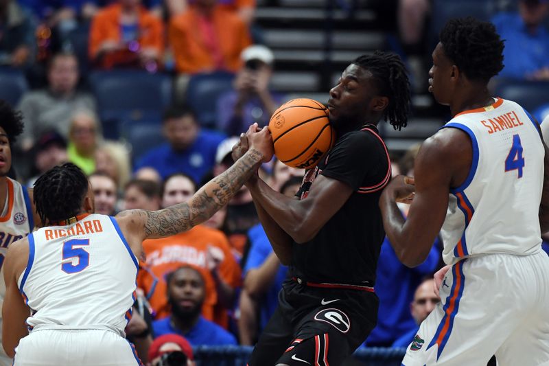 Mar 14, 2024; Nashville, TN, USA; Georgia Bulldogs forward Dylan James (13) holds onto the ball as he is defended by Florida Gators guard Will Richard (5) /and forward Tyrese Samuel (4) during the first half at Bridgestone Arena. Mandatory Credit: Christopher Hanewinckel-USA TODAY Sports