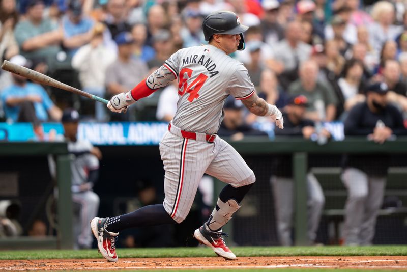 Jun 28, 2024; Seattle, Washington, USA; Minnesota Twins third baseman Jose Miranda (64) hits a single during the third inning against the Seattle Mariners at T-Mobile Park. Mandatory Credit: Stephen Brashear-USA TODAY Sports