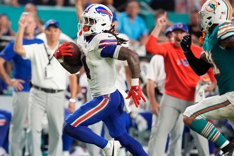 Buffalo Bills running back James Cook (4) runs for a touchdown during the first half of an NFL football game against the Miami Dolphins, Thursday, Sept. 12, 2024, in Miami Gardens, Fla. (AP Photo/Rebecca Blackwell)