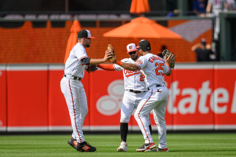 Aug 6, 2023; Baltimore, Maryland, USA; Baltimore Orioles right fielder Anthony Santander (25) left fielder Colton Cowser (17) and right fielder Ryan McKenna (26) celebrate after the win against the New York Mets at Oriole Park at Camden Yards. Mandatory Credit: Reggie Hildred-USA TODAY Sports