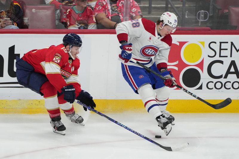 Dec 30, 2023; Sunrise, Florida, USA;  Montreal Canadiens center Christian Dvorak (28) and Florida Panthers left wing Matthew Tkachuk (19) battle for possession during the third period at Amerant Bank Arena. Mandatory Credit: Jim Rassol-USA TODAY Sports