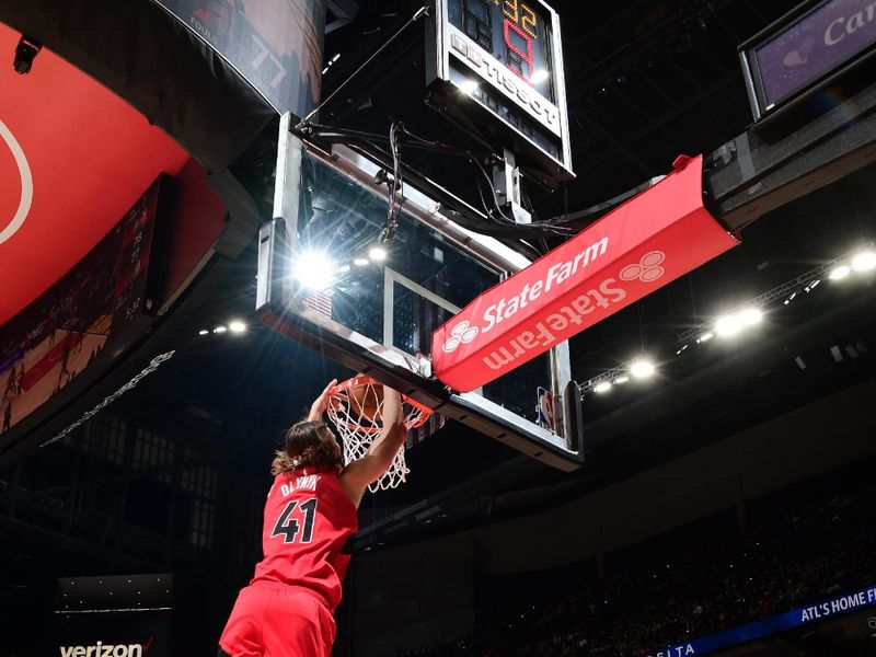 ATLANTA, GA - February 23:   Kelly Olynyk #41 of the Toronto Raptors dunks the ball during the game against the Atlanta Hawks on February 23, 2024 at State Farm Arena in Atlanta, Georgia.  NOTE TO USER: User expressly acknowledges and agrees that, by downloading and/or using this Photograph, user is consenting to the terms and conditions of the Getty Images License Agreement. Mandatory Copyright Notice: Copyright 2024 NBAE (Photo by Scott Cunningham/NBAE via Getty Images)