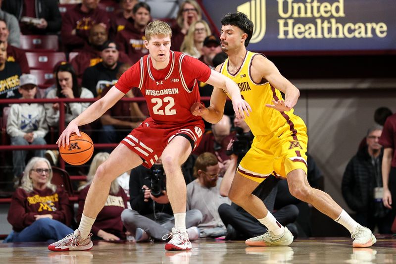 Mar 5, 2025; Minneapolis, Minnesota, USA; Wisconsin Badgers forward Steven Crowl (22) dribbles as Minnesota Golden Gophers forward Dawson Garcia (3) defends during the first half at Williams Arena. Mandatory Credit: Matt Krohn-Imagn Images