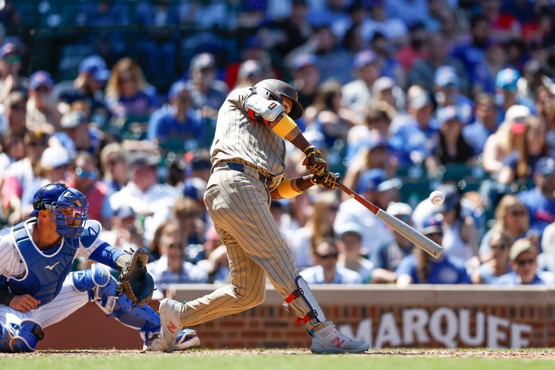 May 8, 2024; Chicago, Illinois, USA; San Diego Padres second base Luis Arraez (4) hits a single against the Chicago Cubs during the fifth inning at Wrigley Field. Mandatory Credit: Kamil Krzaczynski-USA TODAY Sports