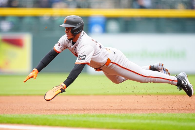 May 9, 2024; Denver, Colorado, USA; San Francisco Giants second base Thairo Estrada (39) leaps toward third base on a steal attempt in the first inning against the Colorado Rockies at Coors Field. Mandatory Credit: Ron Chenoy-USA TODAY Sports