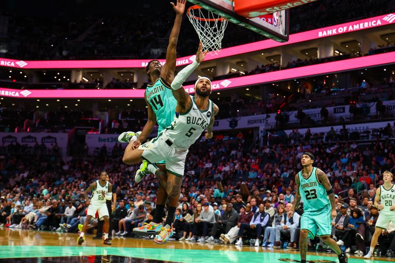 CHARLOTTE, NORTH CAROLINA - NOVEMBER 16: Gary Trent Jr. #5 of the Milwaukee Bucks and Moussa Diabate #14 of the Charlotte Hornets collide mid-air during the second half of a basketball game at Spectrum Center on November 16, 2024 in Charlotte, North Carolina. NOTE TO USER: User expressly acknowledges and agrees that, by downloading and or using this photograph, User is consenting to the terms and conditions of the Getty Images License Agreement. (Photo by David Jensen/Getty Images)