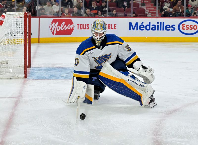 Feb 11, 2024; Montreal, Quebec, CAN; St.Louis Blues goalie Jordan Binnington (50) stops the puck during the second period of the game against the Montreal Canadiens at the Bell Centre. Mandatory Credit: Eric Bolte-USA TODAY Sports