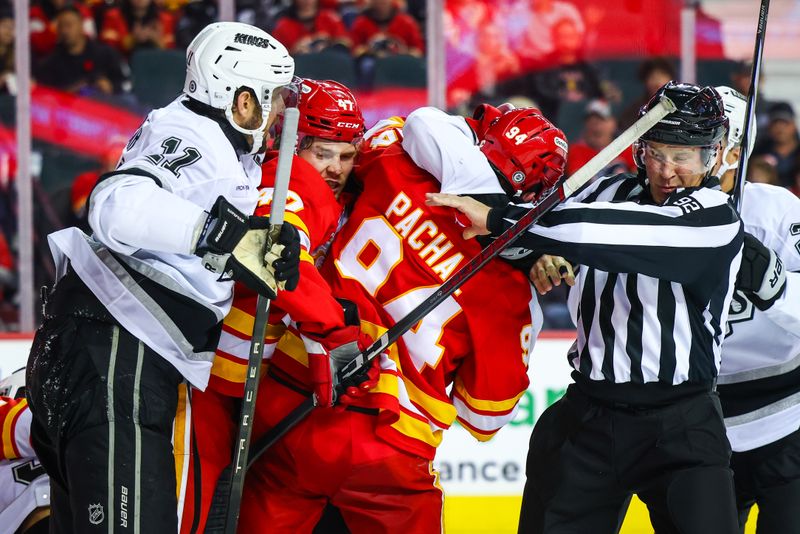 Nov 11, 2024; Calgary, Alberta, CAN; Calgary Flames defenseman Brayden Pachal (94) and Los Angeles Kings right wing Alex Laferriere (14) gets into a scrum during the third period at Scotiabank Saddledome. Mandatory Credit: Sergei Belski-Imagn Images