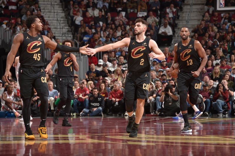 CLEVELAND, OH - November 15: Donovan Mitchell #45 and Ty Jerome #2 of the Cleveland Cavaliers high five during the game against the Chicago Bulls during the Emirates NBA Cup game on November 15, 2024 at Rocket Mortgage FieldHouse in Cleveland, Ohio. NOTE TO USER: User expressly acknowledges and agrees that, by downloading and/or using this Photograph, user is consenting to the terms and conditions of the Getty Images License Agreement. Mandatory Copyright Notice: Copyright 2024 NBAE (Photo by David Liam Kyle/NBAE via Getty Images)