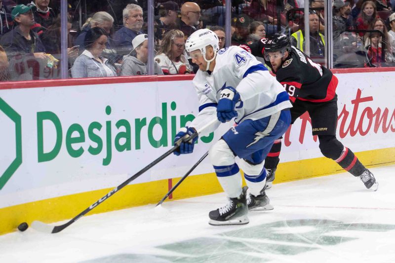 Oct 19, 2024; Ottawa, Ontario, CAN; Tampa Bay Lightning defenseman Darren Raddysh (43) skates with the puck in front of Ottawa Senators right wing Drake Batherson (19) in the first period at the Canadian Tire Centre. Mandatory Credit: Marc DesRosiers-Imagn Images