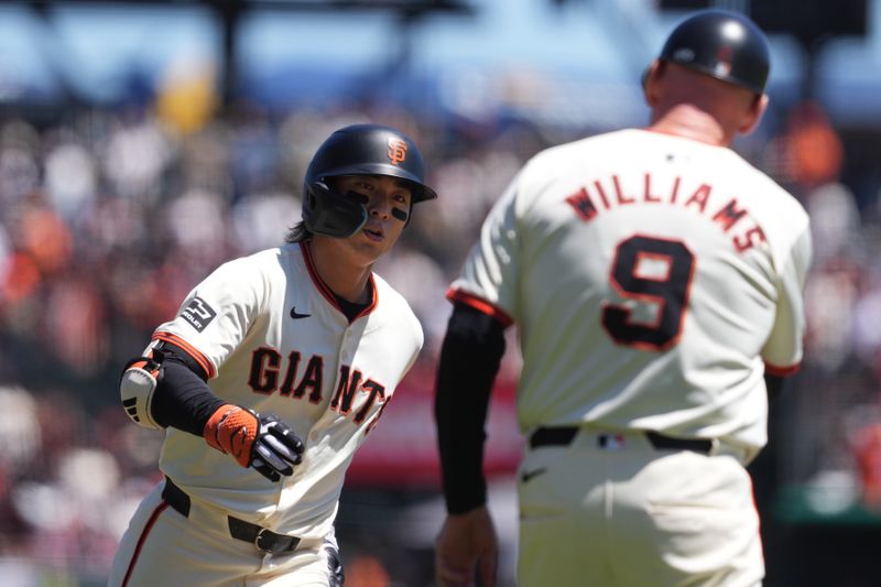 Apr 20, 2024; San Francisco, California, USA; San Francisco Giants outfielder Jung Hoo Lee (left) is congratulated by third base coach Matt Williams (9) after hitting a home run against the Arizona Diamondbacks during the first inning at Oracle Park. Mandatory Credit: Darren Yamashita-USA TODAY Sports