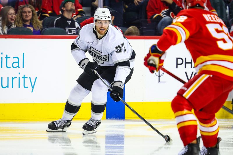 Nov 11, 2024; Calgary, Alberta, CAN; Los Angeles Kings left wing Warren Foegele (37) controls the puck against the Calgary Flames during the third period at Scotiabank Saddledome. Mandatory Credit: Sergei Belski-Imagn Images