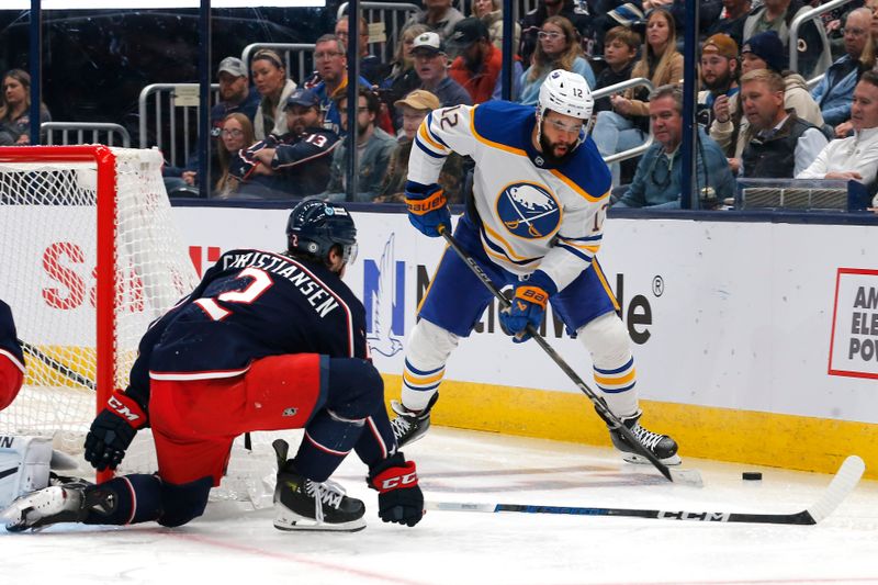 Oct 17, 2024; Columbus, Ohio, USA; Columbus Blue Jackets defenseman Jake Christiansen (2) defends as Buffalo Sabres left wing  Jordan Greenway (12) looks to pass during the third period at Nationwide Arena. Mandatory Credit: Russell LaBounty-Imagn Images