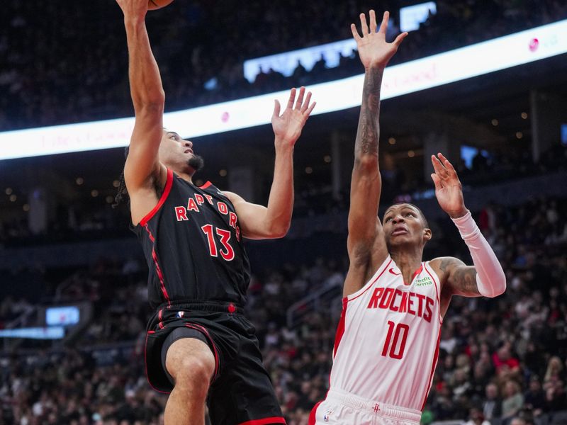 TORONTO, ON - FEBRUARY 9: Jordan Nwora #13 of the Toronto Raptors shoots against Jabari Smith #10 of the Houston Rockets during the first half of their basketball game at the Scotiabank Arena on February 9, 2024 in Toronto, Ontario, Canada. NOTE TO USER: User expressly acknowledges and agrees that, by downloading and/or using this Photograph, user is consenting to the terms and conditions of the Getty Images License Agreement. (Photo by Mark Blinch/Getty Images)