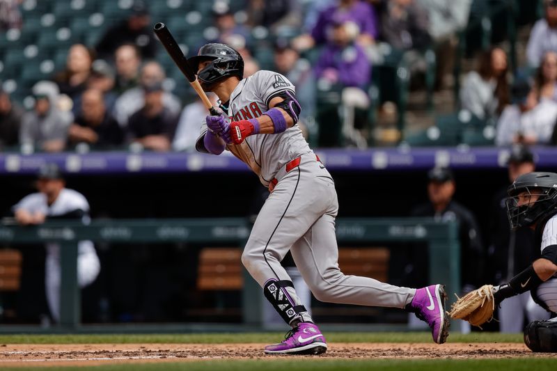 Apr 10, 2024; Denver, Colorado, USA; Arizona Diamondbacks left fielder Lourdes Gurriel Jr. (12) hits an RBI double in the seventh inning against the Colorado Rockies at Coors Field. Mandatory Credit: Isaiah J. Downing-USA TODAY Sports