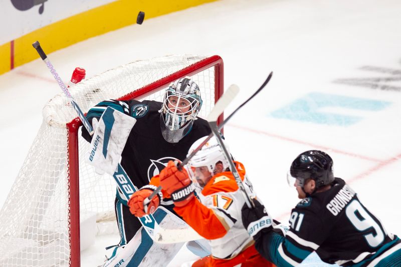 Oct 12, 2024; San Jose, California, USA; San Jose Sharks goaltender Vitek Vanecek (41) watches a shot on goal go high over his head as Anaheim Ducks left winger Alex Killorn (17) and Sharks right winger Carl Grundstrom (91) tangle in front of the net during the third period at SAP Center at San Jose. Mandatory Credit: D. Ross Cameron-Imagn Images