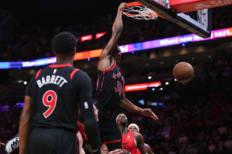 MIAMI, FLORIDA - DECEMBER 12: Ochai Agbaji #30 of the Toronto Raptors dunks the ball against the Miami Heat during the third quarter at Kaseya Center on December 12, 2024 in Miami, Florida. NOTE TO USER: User expressly acknowledges and agrees that, by downloading and or using this Photograph, user is consenting to the terms and conditions of the Getty Images License Agreement. (Photo by Rich Storry/Getty Images)