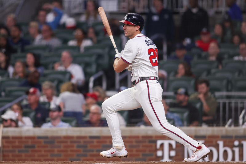 May 7, 2025; Atlanta, Georgia, USA; Atlanta Braves first baseman Matt Olson (28) hits a RBI single against the Cincinnati Reds in the sixth inning at Truist Park. Mandatory Credit: Brett Davis-Imagn Images
