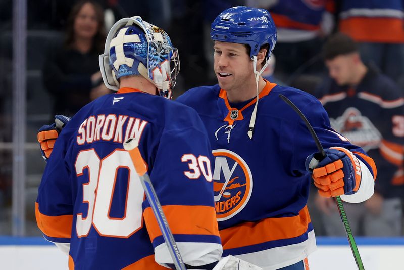 Nov 30, 2024; Elmont, New York, USA; New York Islanders left wing Matt Martin (17) celebrates with goaltender Ilya Sorokin (30) after defeating the Buffalo Sabres at UBS Arena. Mandatory Credit: Brad Penner-Imagn Images