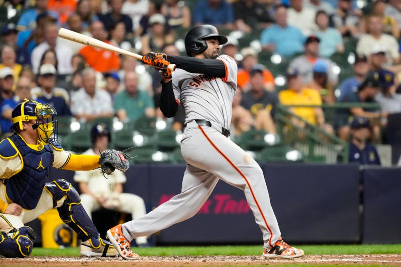 Aug 27, 2024; Milwaukee, Wisconsin, USA;  San Francisco Giants first baseman LaMonte Wade Jr. (31) drives in a run during the third inning against the Milwaukee Brewers at American Family Field. Mandatory Credit: Jeff Hanisch-USA TODAY Sports