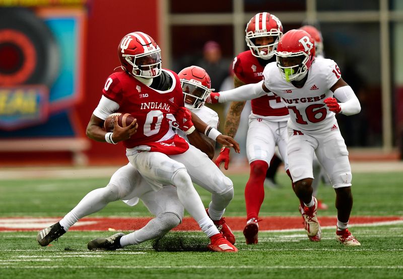 Nov 13, 2021; Bloomington, Indiana, USA;  Indiana Hoosiers quarterback Donaven McCulley (0) is sacked by Rutgers Scarlet Knights defensive back Christian Izien (0) during the second half at Memorial Stadium. The Scarlet Knights won 38-3.  Mandatory Credit: Marc Lebryk-USA TODAY Sports