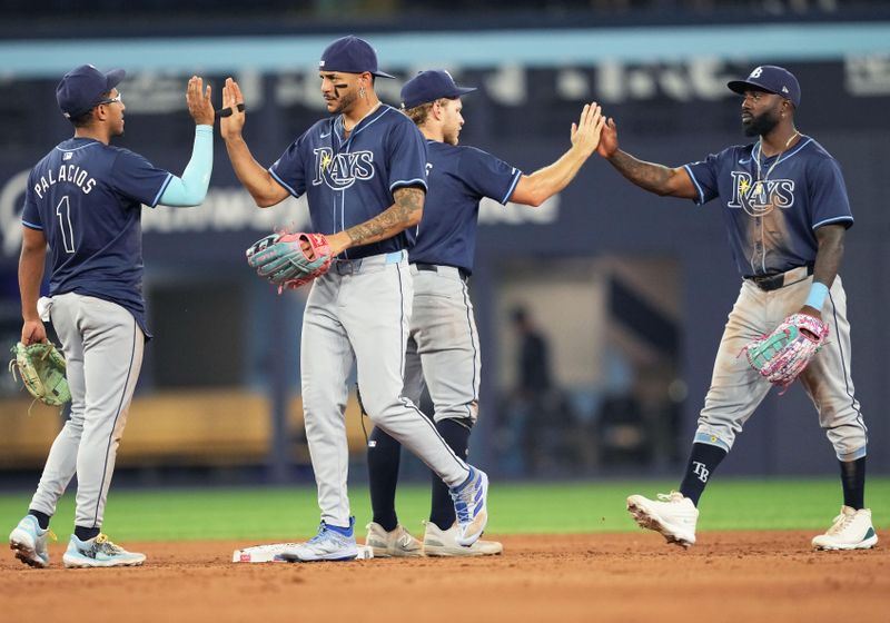 Jul 23, 2024; Toronto, Ontario, CAN; Tampa Bay Rays second baseman Richie Palacios (1) and center fielder Jose Siri (22) celebrate the win against the Toronto Blue Jays at the end of the ninth inning at Rogers Centre. Mandatory Credit: Nick Turchiaro-USA TODAY Sports