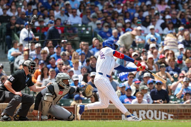 May 17, 2025; Chicago, Illinois, USA; Chicago Cubs right fielder Pete Crow-Armstrong (4) hits a two-run single against the Chicago White Sox during the second inning at Wrigley Field. Mandatory Credit: Kamil Krzaczynski-Imagn Images