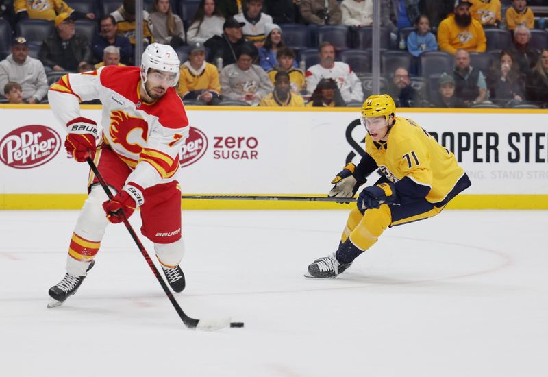 Nov 1, 2025; Nashville, Tennessee, USA; Calgary Flames defenseman Kevin Bahl (7) plays the puck against Nashville Predators right wing Matthew Wood (71) during the first period at Bridgestone Arena. Mandatory Credit: Alan Poizner-Imagn Images