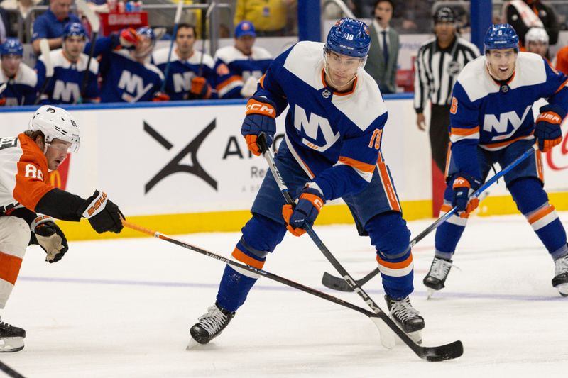 Nov 25, 2023; Elmont, New York, USA; New York Islanders left wing Pierre Engvall (18) looks to move the puck against the Philadelphia Flyers during the second period at UBS Arena. Mandatory Credit: Thomas Salus-USA TODAY Sports