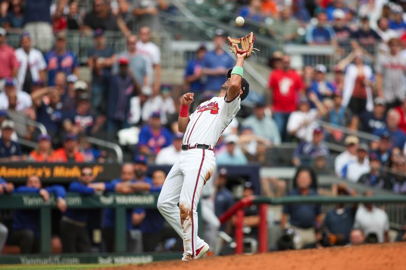 Sep 30, 2024; Atlanta, Georgia, USA; Atlanta Braves left fielder Whit Merrifield (15) catches a pop fly against the New York Mets in the ninth inning at Truist Park. Mandatory Credit: Brett Davis-Imagn Images
