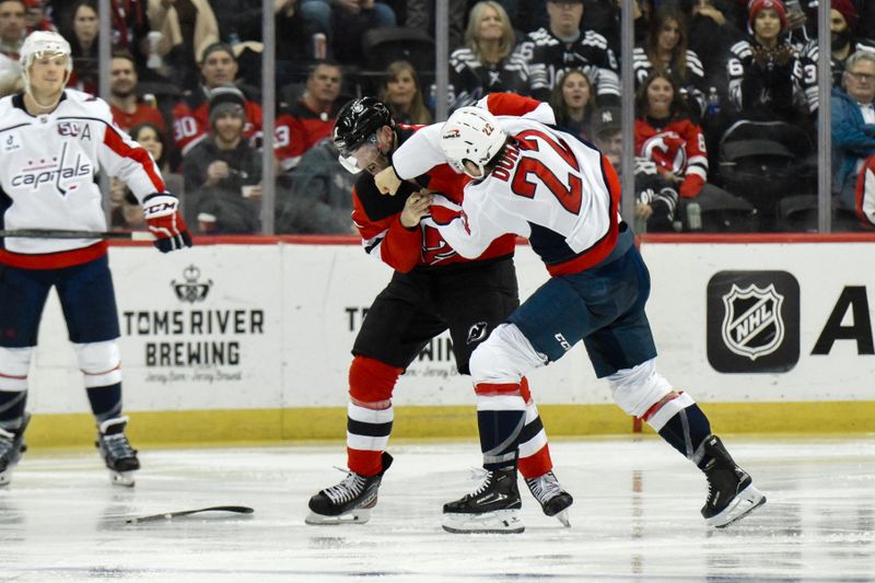 Oct 19, 2024; Newark, New Jersey, USA; New Jersey Devils right wing Stefan Noesen (11) and Washington Capitals right wing Brandon Duhaime (22) fight during the third period at Prudential Center. Mandatory Credit: John Jones-Imagn Images