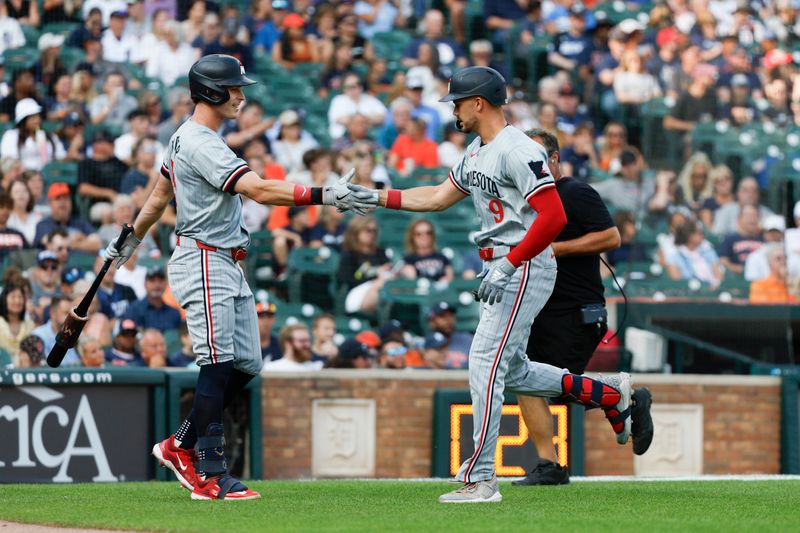 Jul 26, 2024; Detroit, Michigan, USA; Minnesota Twins outfielder Trevor Larnach (9) high-fives Minnesota Twins outfielder Max Kepler (26) after scoring a home run in the first inning against the Detroit Tigers at Comerica Park. Mandatory Credit: Brian Bradshaw Sevald-USA TODAY Sports